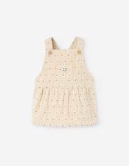 Braga de pana beige para bebé niña con puntos y bolsillo frontal