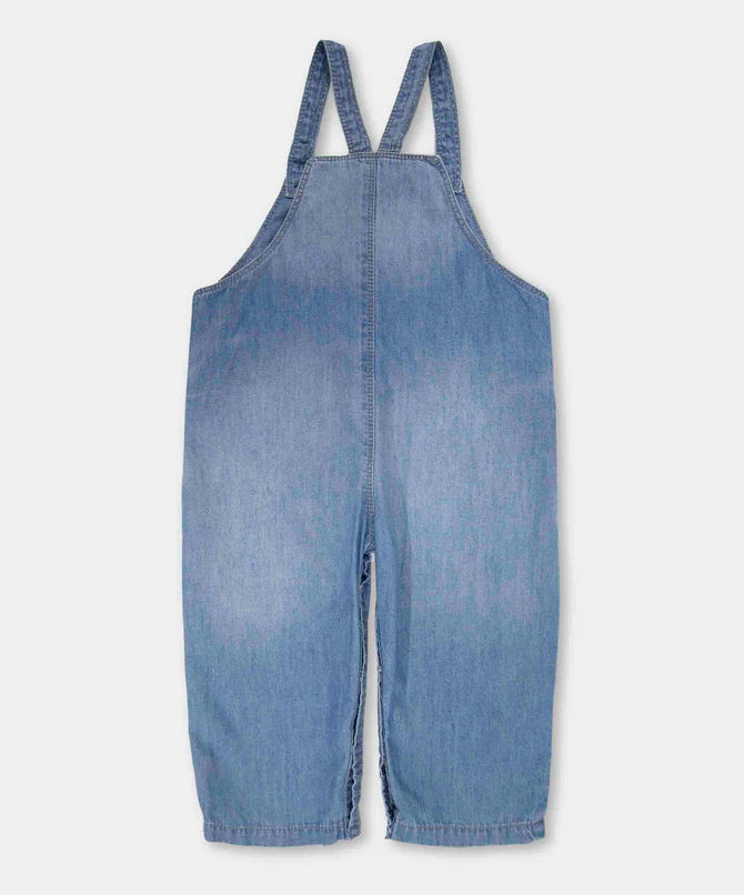 Enterizo denim bebé azul medio tirantes cruzados 12‑24 m