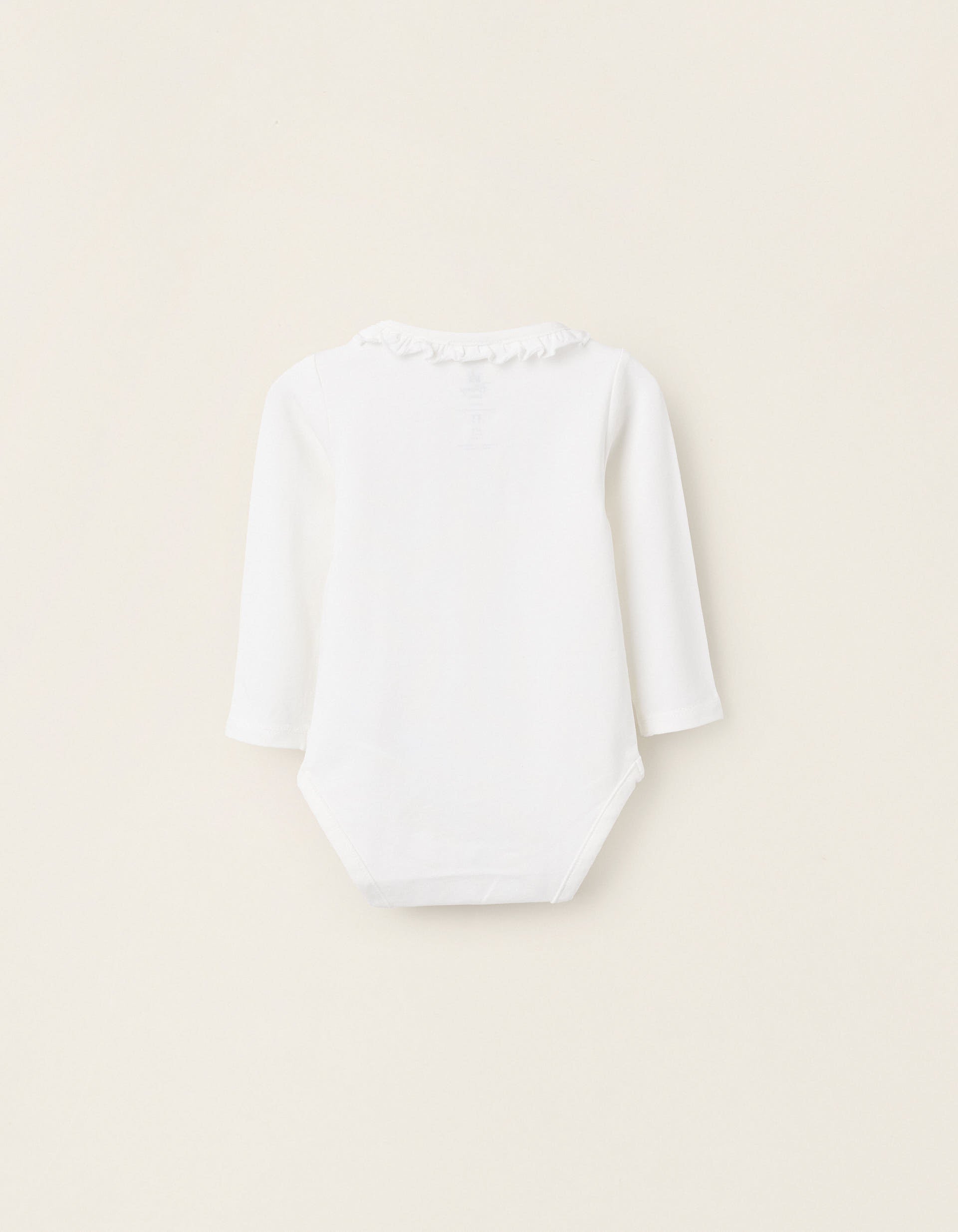 Body blanco para bebé con cuello de volantes y manga larga